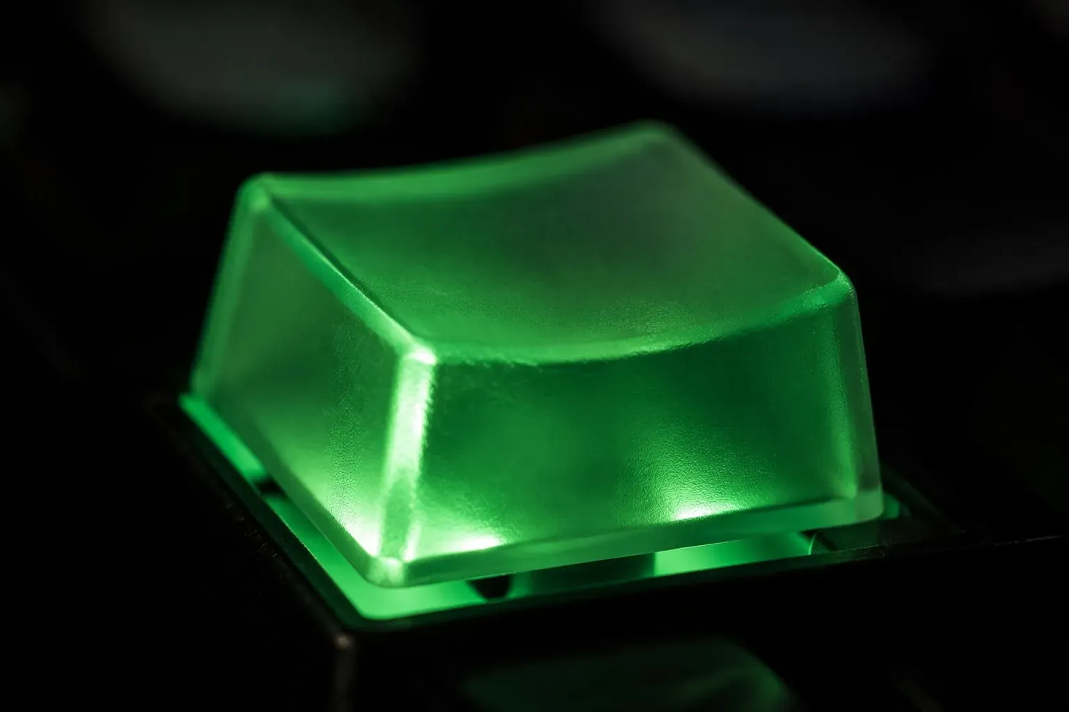 A single backlit mechanical keyboard key glowing emerald green — software automation craft